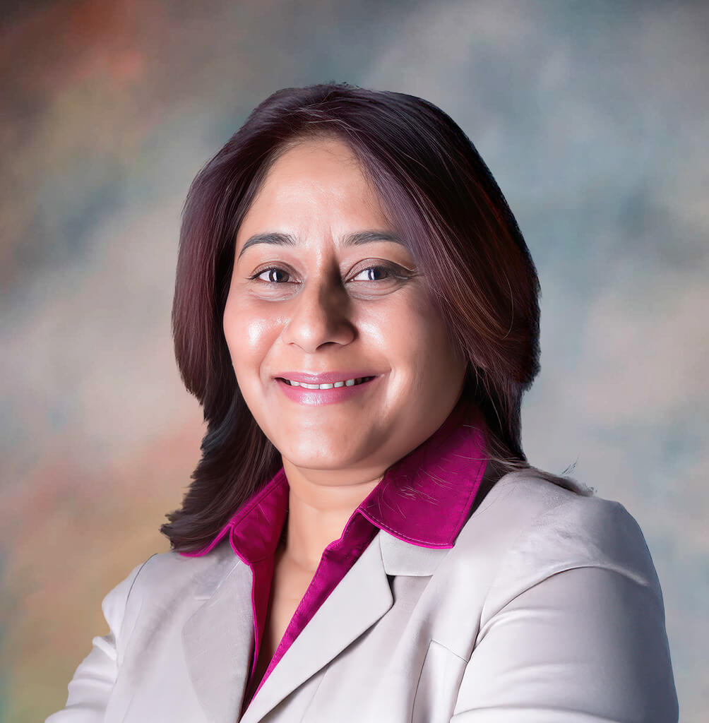 Professional headshot of a smiling female physician wearing a white lab coat
